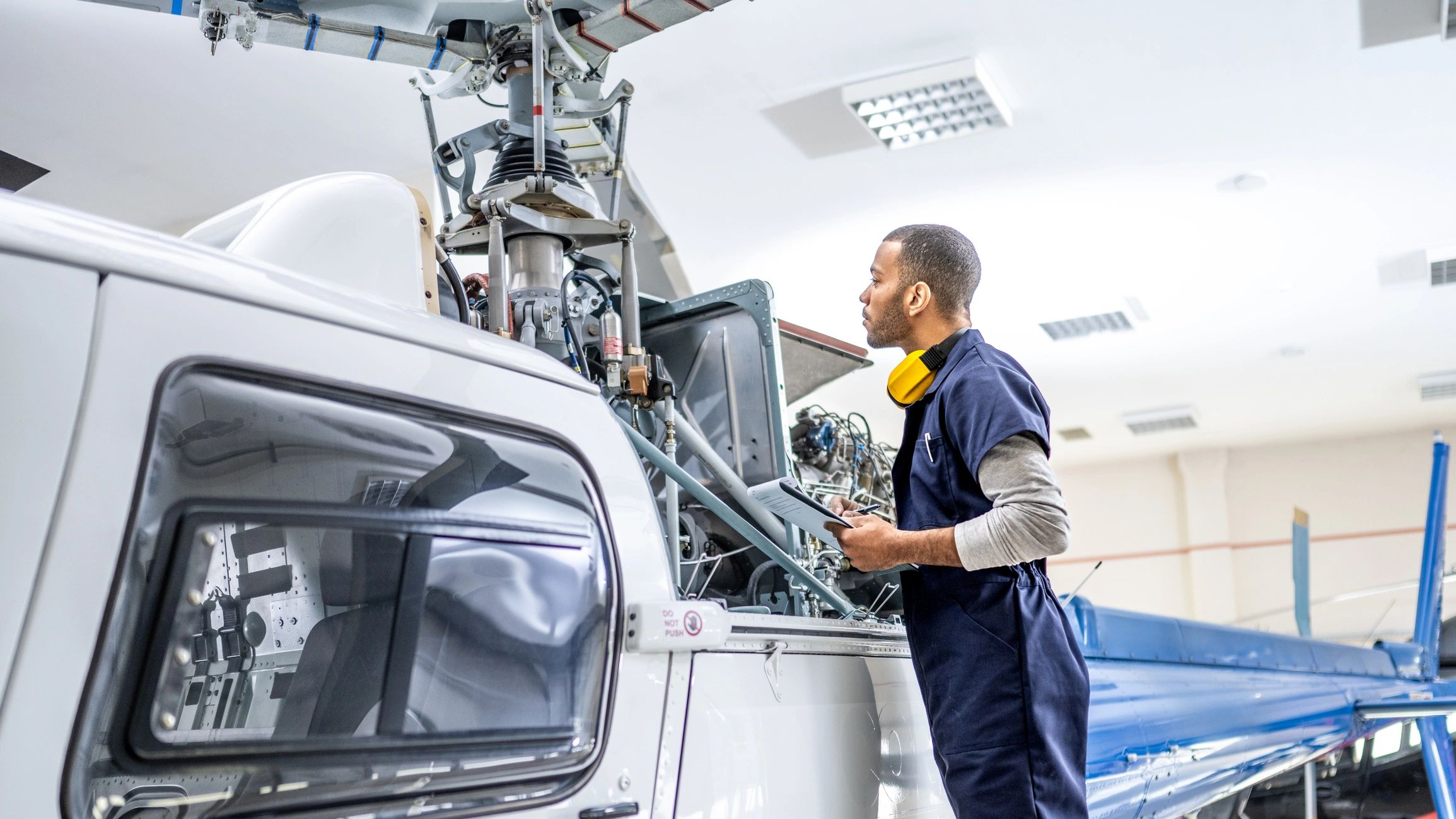 Engineer inspecting aircraft components in a hangar