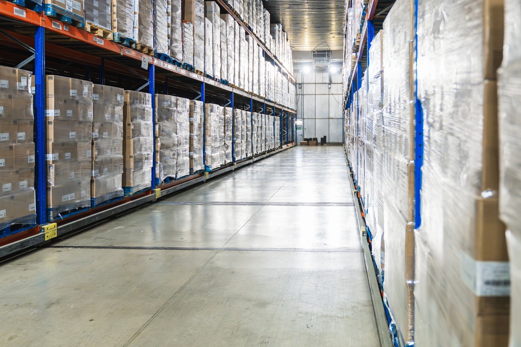 Palletized boxes in a logistics warehouse aisle